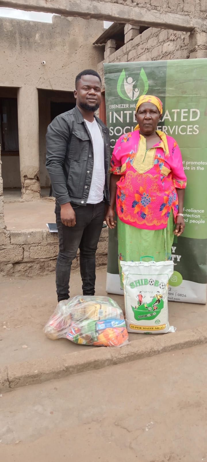 EMISSC handing over a food parcel